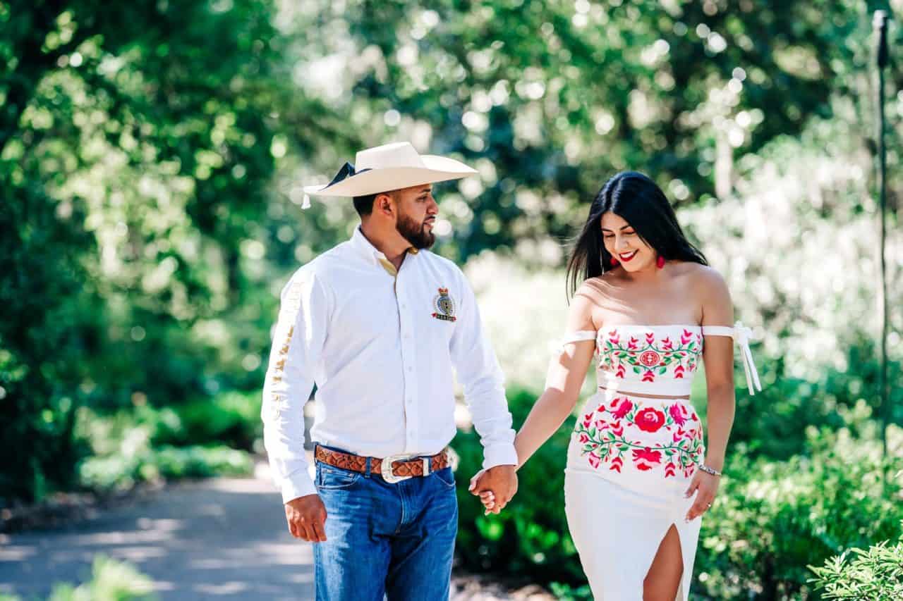 Couple walking and holding hands at Bok Tower Gardens during an engagement photography session