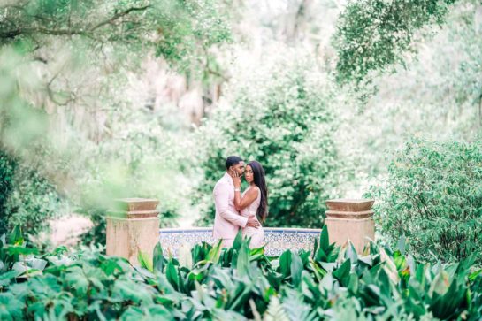 Bok Tower Gardens Engagement session of two people standing in a garden area embracing each other for a subtle kiss.